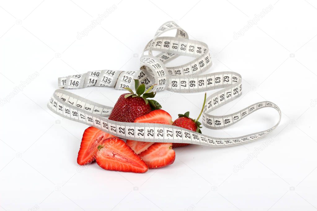 big juicy red ripe strawberries and measure tape isolated on white