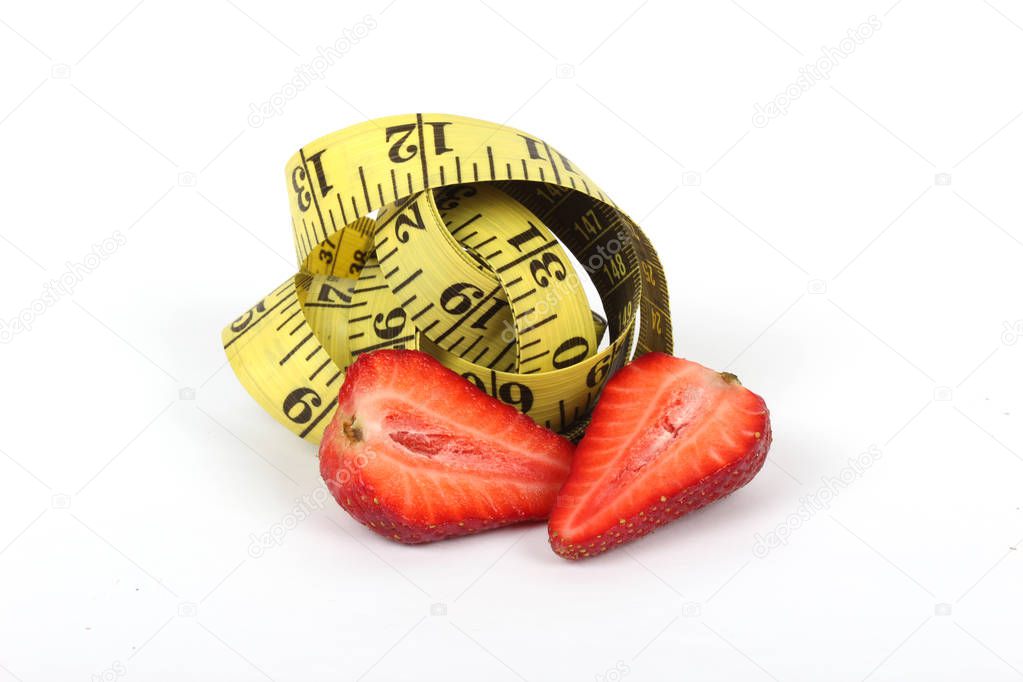 big juicy red ripe strawberries and measure tape isolated on white