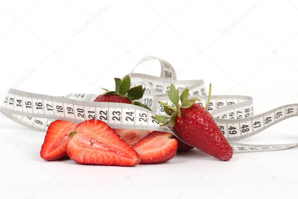 big juicy red ripe strawberries and measure tape isolated on white