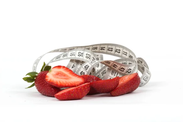 Big juicy red ripe strawberries and measure tape isolated on white Stock Photo