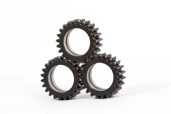 Small group of gears with their teeth engaged on a white background.