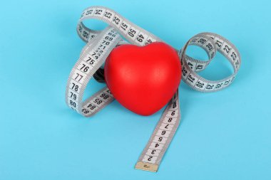 On blue background and red heart tape measure.Fitness, Health, Medical, diet concept
