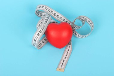 On blue background and red heart tape measure.Fitness, Health, Medical, diet concept