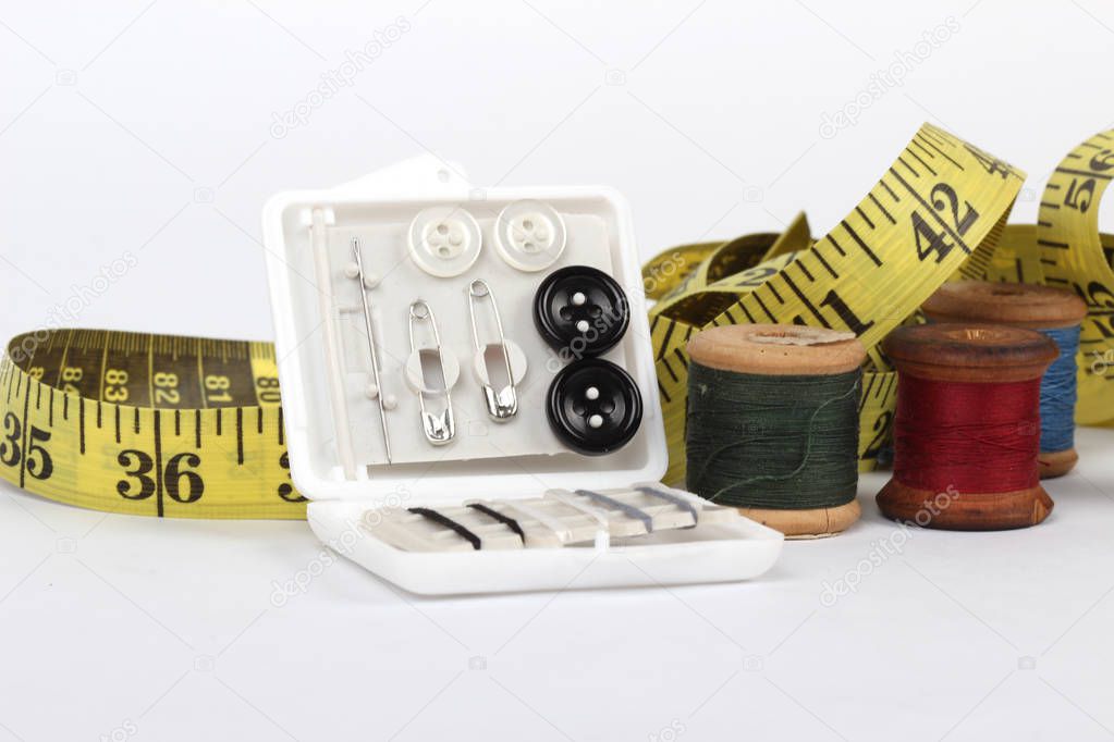 sewing items and tape measure isolated on a white background