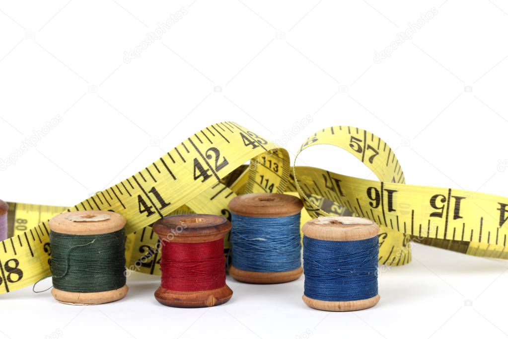 sewing items and tape measure isolated on a white background