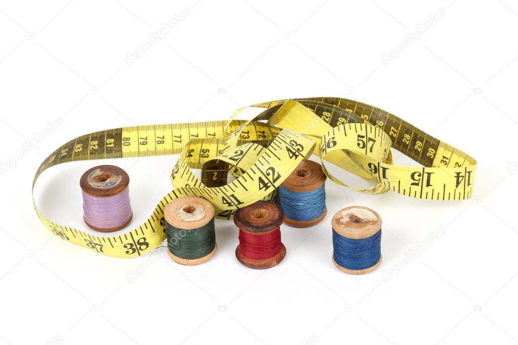 sewing items and tape measure isolated on a white background