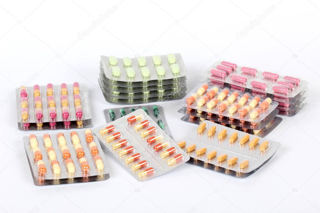 Medical bottles and pills on white