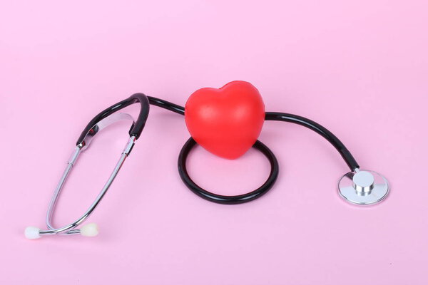 stethoscope and heart isolated on pink background