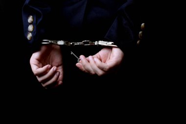 Kadınlar elleri kelepçeli.