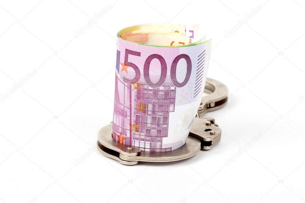 Money and handcuffs. Concept for corruption, fraud, money laundry