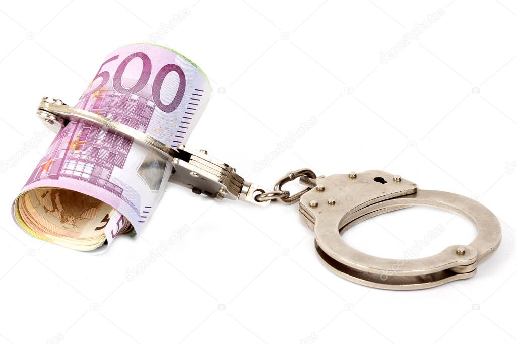 Money and handcuffs. Concept for corruption, fraud, money laundry