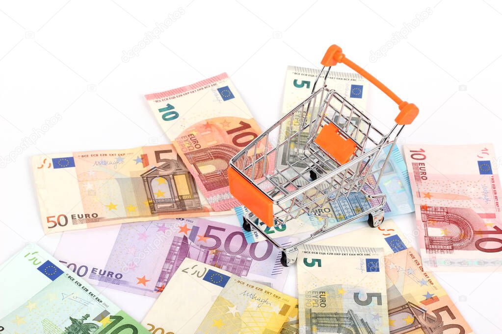 A shopping cart and euro banknotes