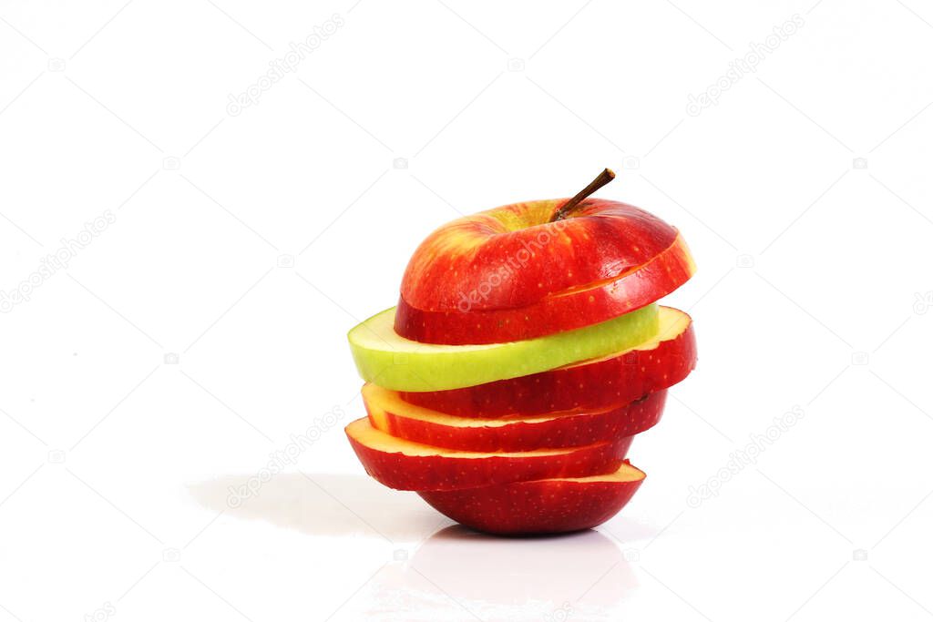sliced red and green apple on white ground 