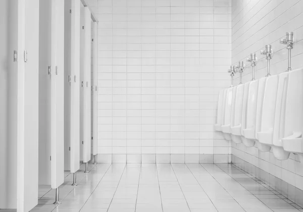 Azulejos de primer plano pared en el inodoro del hombre con vista al inodoro por urinarios y habitación pequeña, interior en el viejo fondo del inodoro en tono blanco y negro, interior del inodoro en la oficina —  Fotos de Stock