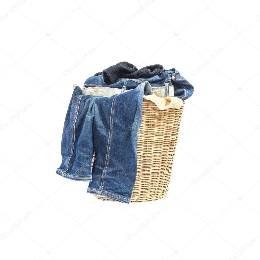 Closeup wood weave basket for used clothes with pile of clothes in house isolated on white background