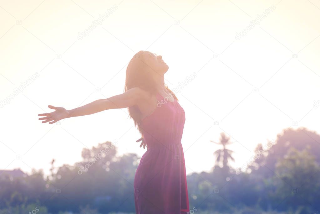 Young beauty woman happy relaxing smile in summer sunset sky out