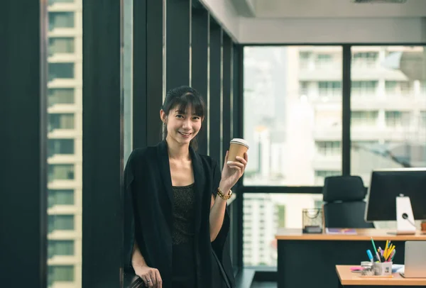 Entrepreneur pretty asian woman holding coffee cup