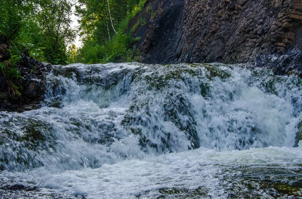 falling water in the morning mist. falling water in the dense morning fog. Water falling from a cliff. falling from a height of water. falling water in the fog. thick morning fog in the summer forest.