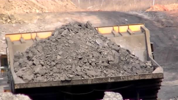 Hydraulic excavator loads blasted rock to BelAZ — Stock Footage Hydraulic Excavator Loads Blasted Rock Belaz Stock Footage