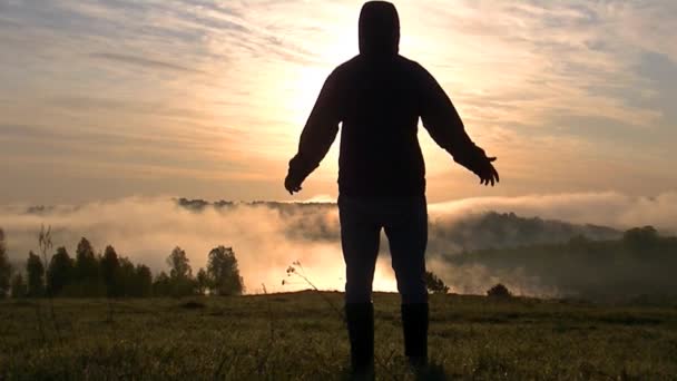 Man Stands His Arms Spread Wide Looks Rising Sun — Stock Video