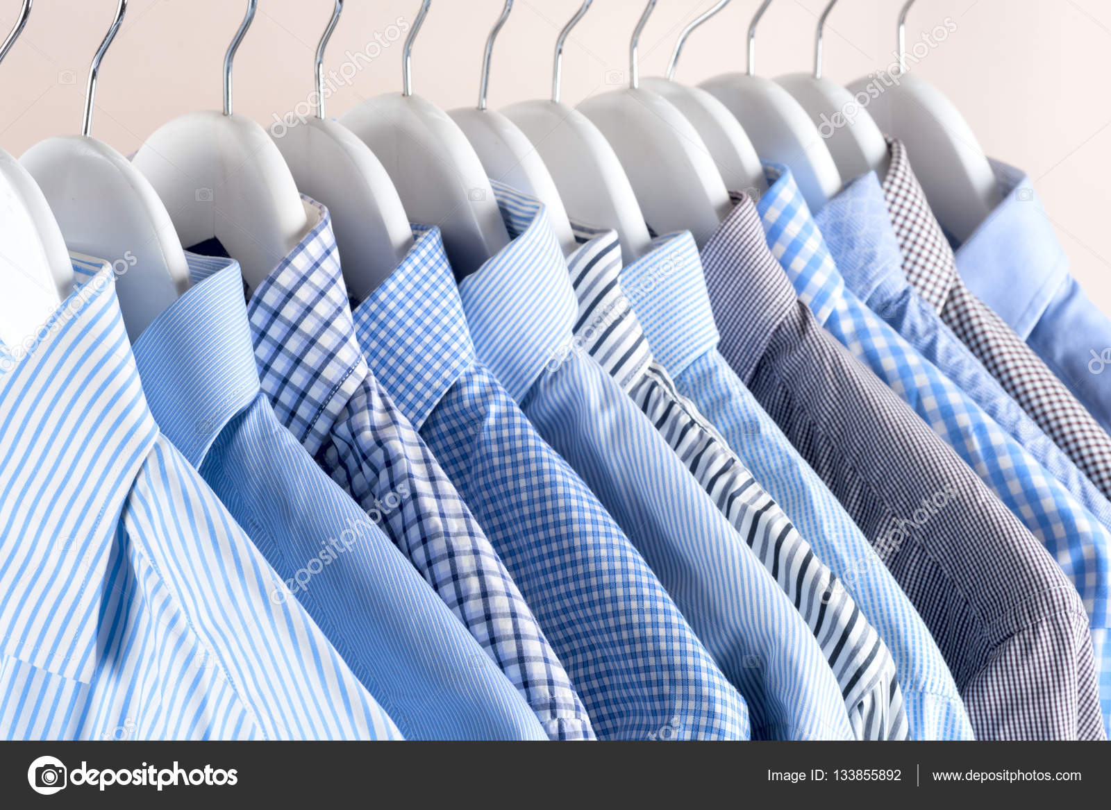 Cloth Hangers with Shirts. Men s clothes Stock Photo vtmila 133855892