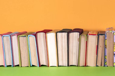 Parlak renkli arka plan üzerinde renkli kitap seti. Okula dönüş