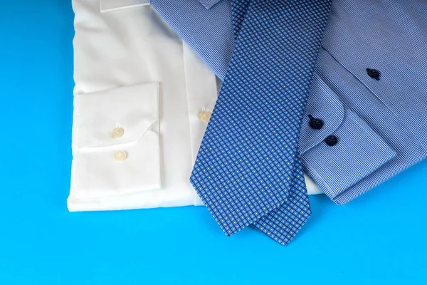 Stack of blue and white shirt closeup on a light background. — Stock Photo, Image