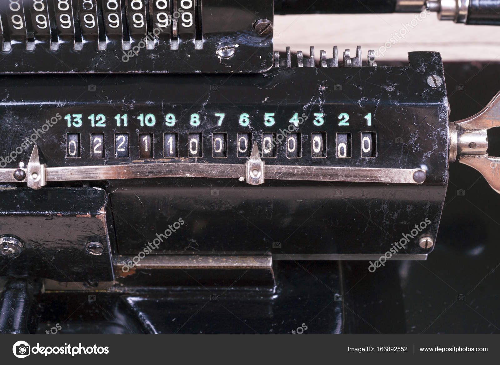 Old rusty retro calculator black standing on a wooden table Stock Photo by  ©vtmila 163892552