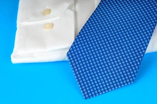 Stack of blue and white shirt closeup on a light background. — Stock Photo, Image