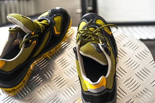 Unbranded modern sneaker in the gym. Black-Yellow. Comfortable shoes.