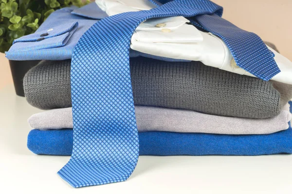 Stack of blue and white shirt closeup on a light background. — Stock Photo, Image