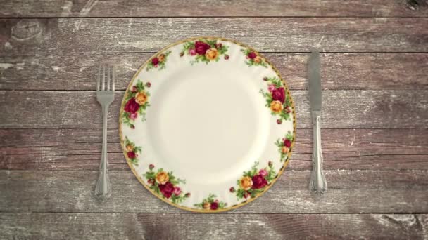Empty Plate Knife and Fork on a Wooden Table in Stop Motion — Stock Video