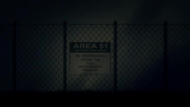 Zoom in an Area 51 Sign on a Metal Fence on a Stormy Night — стоковое видео