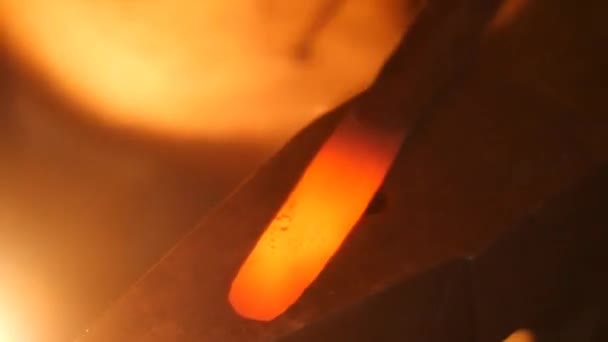 Un forgeron frappant du métal chaud avec un marteau sur une enclume 