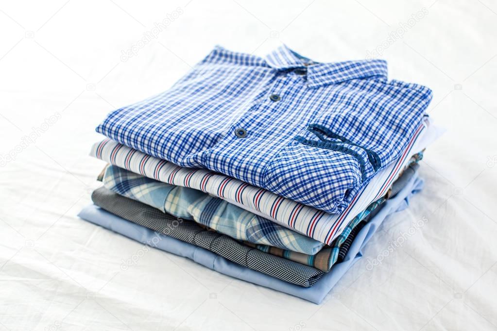 ironed and folded shirts on table