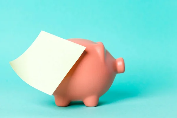 Piggy bank with empty note — Stock Photo, Image