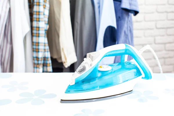 Electric iron with shirts — Stock Photo, Image