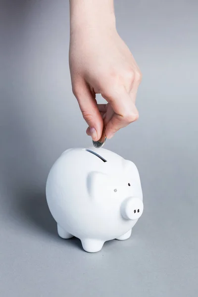 Putting coin into piggy bank — Stock Photo, Image