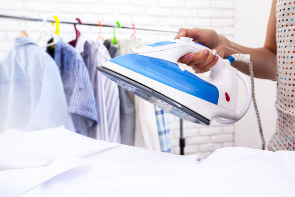 Woman using hot iron steam