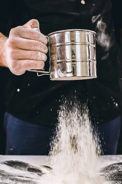 man baker works with flour