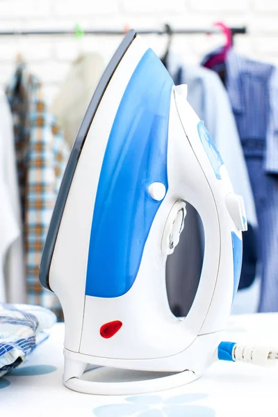 Electric iron with shirts — Stock Photo, Image