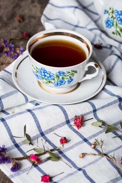 Still life with tea cup and tablecloth — Stock Photo, Image