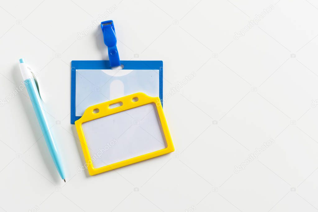 Name tag and a pen on white background