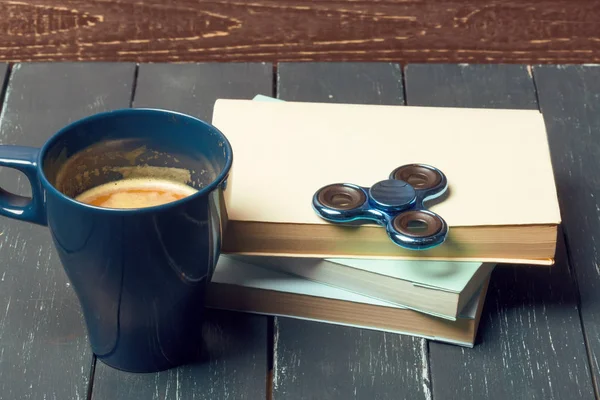 Workplace with coffee cup, spinner and book