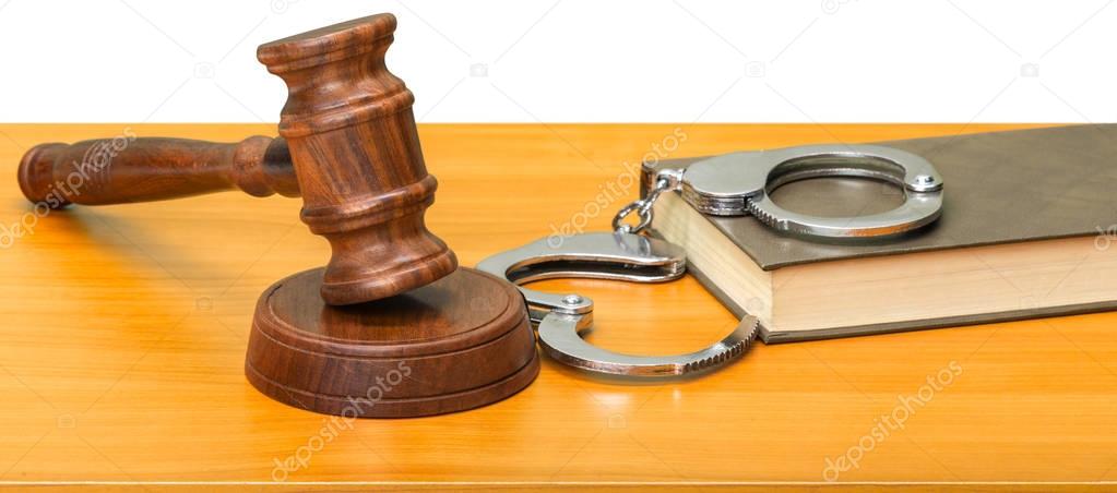 Gavel, books and handcuffs