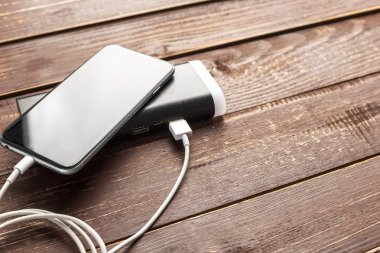 Tablo arka plan üzerinde güç banka ile şarj Smartphone