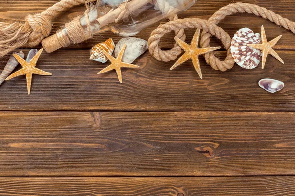 Seashells border on wood. Marine background.