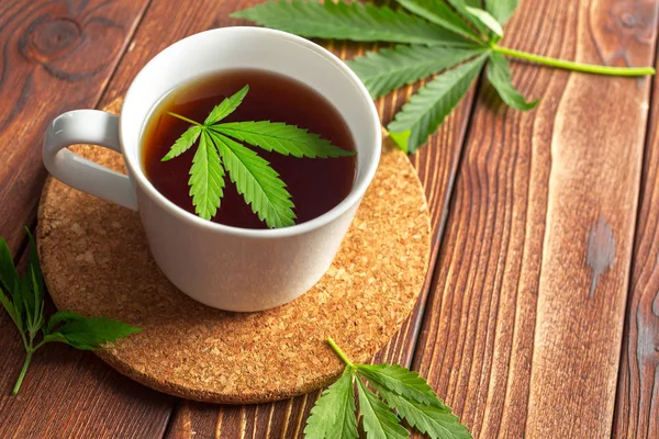 Cannabis herbal tea and marijuana leaves