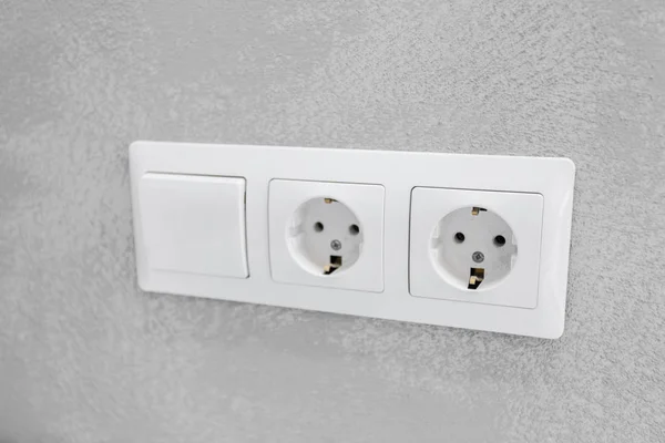 Electric Socket Closeup on white wall
