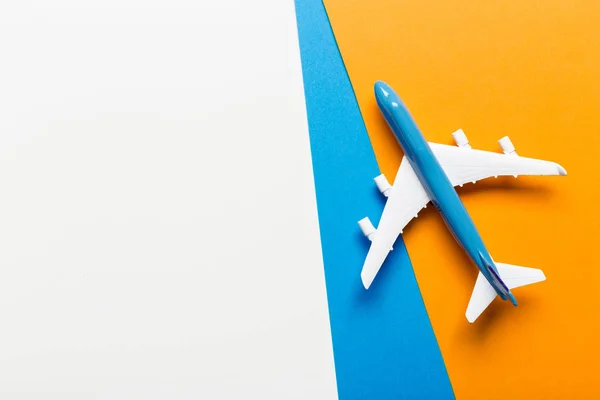 Miniature airplane on colourful background for travel theme